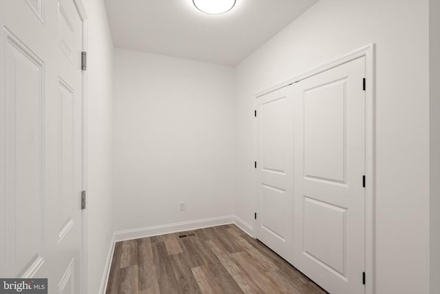  - laundry area featuring wood finished floors and baseboards