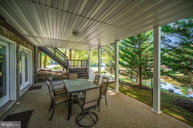 view of patio / terrace featuring stairs and outdoor dining area
