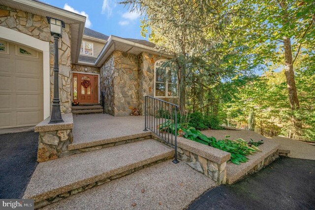 property entrance with stone siding