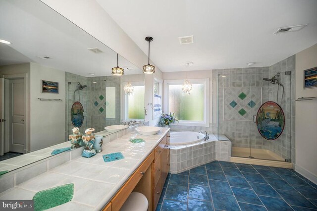 full bathroom with a shower stall, a garden tub, vanity, and tile patterned flooring
