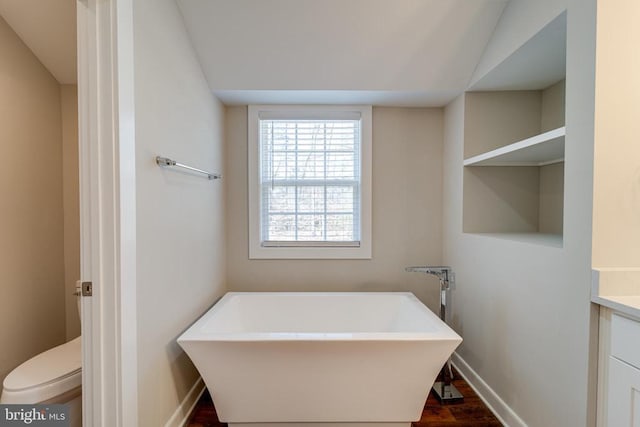 26288 Wisdom Tree Ln, Unionville, VA 22567 - full bath with vanity, a soaking tub, toilet, wood finished floors, and baseboards