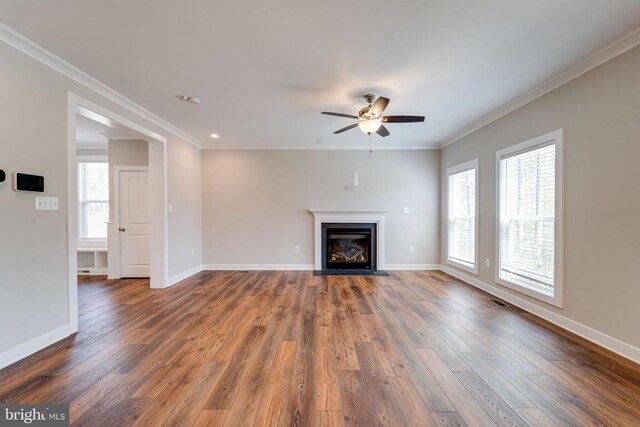 26288 Wisdom Tree Ln, Unionville, VA 22567 - unfurnished living room featuring dark wood-style flooring, a ceiling fan, baseboards, a fireplace with flush hearth, and crown molding