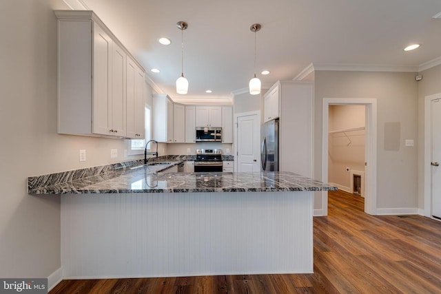 26288 Wisdom Tree Ln, Unionville, VA 22567 - kitchen featuring appliances with stainless steel finishes, a sink, a peninsula, dark stone counters, and ornamental molding