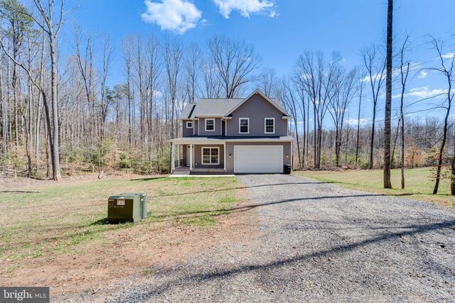26288 Wisdom Tree Ln, Unionville, VA 22567 - view of front of home with a porch, a garage, gravel driveway, and a front lawn