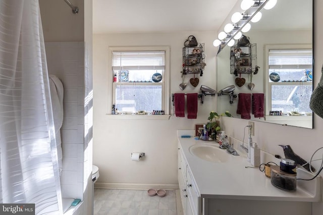 full bath with toilet, vanity, baseboards, and tile patterned floors