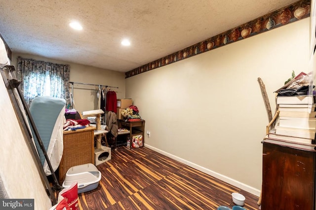 office with a textured ceiling, recessed lighting, dark wood finished floors, and baseboards