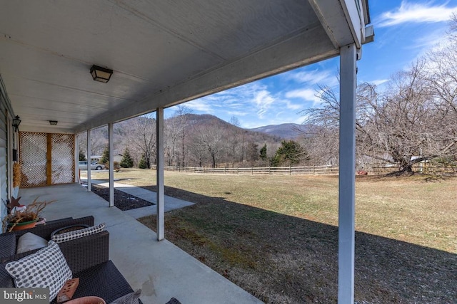 view of yard with fence and a mountain view