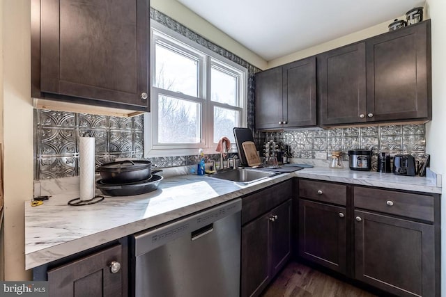 kitchen with dark brown cabinets, tasteful backsplash, light countertops, and dishwasher