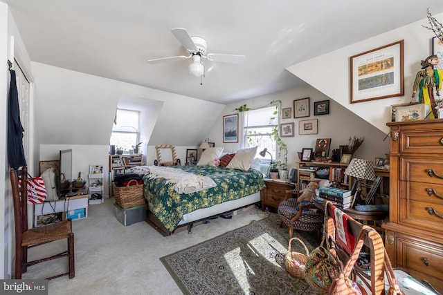 bedroom with vaulted ceiling, a ceiling fan, and light colored carpet