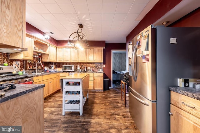 kitchen with tasteful backsplash, appliances with stainless steel finishes, pendant lighting, light brown cabinetry, and open shelves