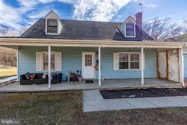 view of front facade with covered porch and a shingled roof