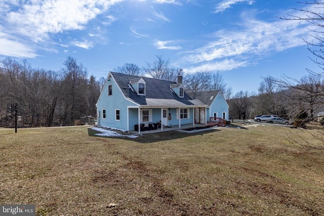 back of property featuring a chimney and a lawn