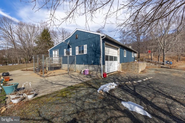 view of property exterior with a garage and aphalt driveway