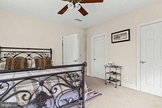 carpeted bedroom featuring baseboards and ceiling fan