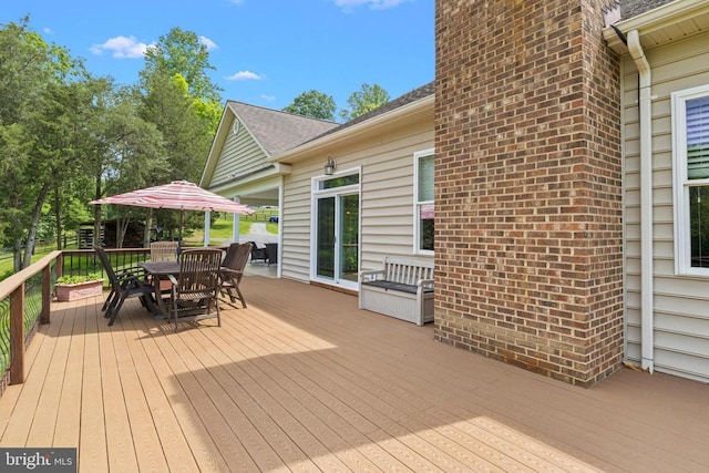 wooden deck featuring outdoor dining space
