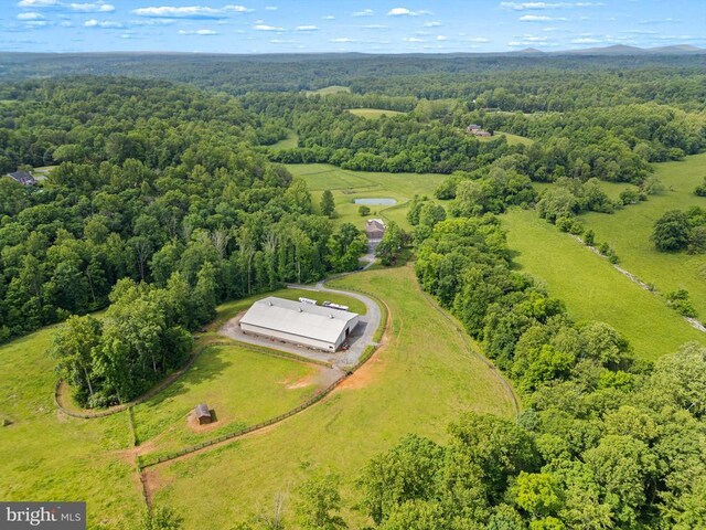 bird's eye view of a heavily wooded area and a large body of water