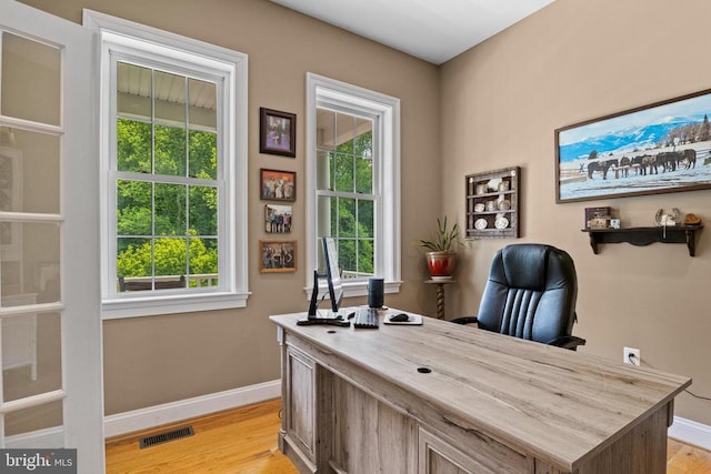 office space featuring baseboards and light wood-style floors