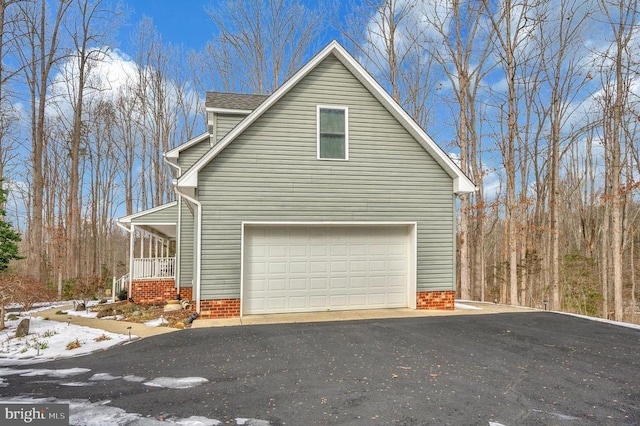 6117 Block House Rd, Partlow, VA 22534 - view of side of home featuring asphalt driveway, a garage, and a porch