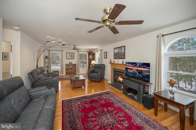 6117 Block House Rd, Partlow, VA 22534 - living room featuring a ceiling fan, healthy amount of natural light, light wood-style floors, and a fireplace with flush hearth