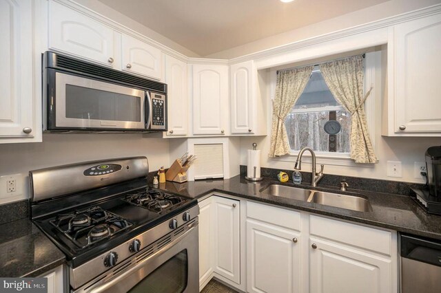 6117 Block House Rd, Partlow, VA 22534 - kitchen with stainless steel appliances, a sink, white cabinets, and dark stone countertops