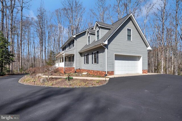 6117 Block House Rd, Partlow, VA 22534 - view of side of property with driveway, a garage, roof with shingles, and covered porch
