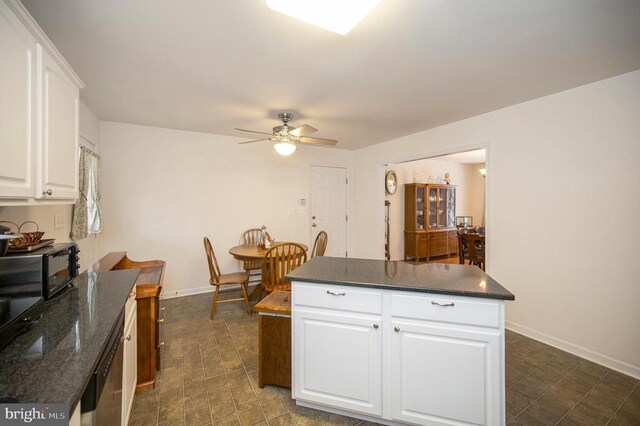 6117 Block House Rd, Partlow, VA 22534 - kitchen with a ceiling fan, white cabinets, a center island, and baseboards