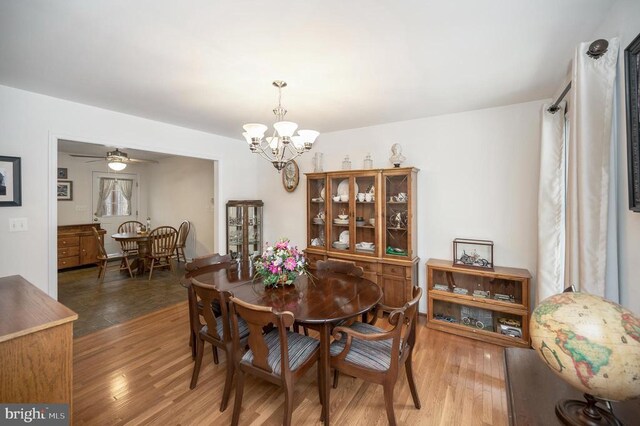 6117 Block House Rd, Partlow, VA 22534 - dining room with a chandelier, wood finished floors, and a ceiling fan
