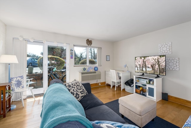 1800 Jefferson Park Ave Unit 39, Charlottesville, VA 22903 - living room featuring healthy amount of natural light, wood finished floors, and a wall mounted AC