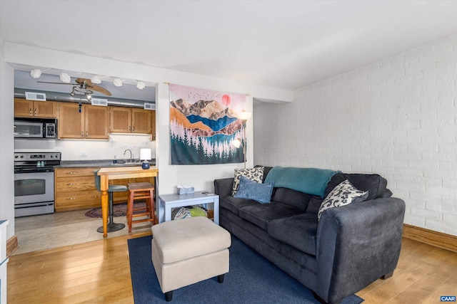 1800 Jefferson Park Ave Unit 39, Charlottesville, VA 22903 - living area with light wood-style flooring and brick wall