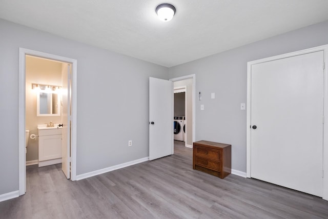 129 Hillwood Dr, Front Royal, VA 22630 - unfurnished bedroom with washing machine and dryer, wood finished floors, and connected bathroom