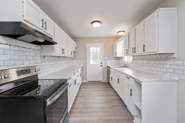 129 Hillwood Dr, Front Royal, VA 22630 - kitchen featuring electric range, under cabinet range hood, light countertops, light wood-style flooring, and white cabinets