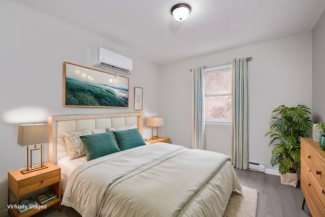129 Hillwood Dr, Front Royal, VA 22630 - bedroom with a wall mounted air conditioner, wood finished floors, and a baseboard heating unit