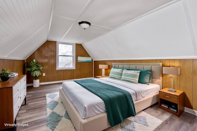 129 Hillwood Dr, Front Royal, VA 22630 - bedroom featuring wooden walls, light wood-style floors, and vaulted ceiling