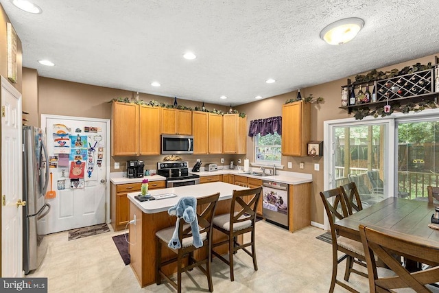 12407 Salient Ln, Spotsylvania, VA 22551 - kitchen featuring stainless steel appliances, light countertops, a center island, light floors, and recessed lighting