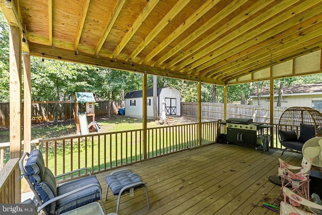 12407 Salient Ln, Spotsylvania, VA 22551 - wooden deck with a shed, a fenced backyard, a grill, and a playground