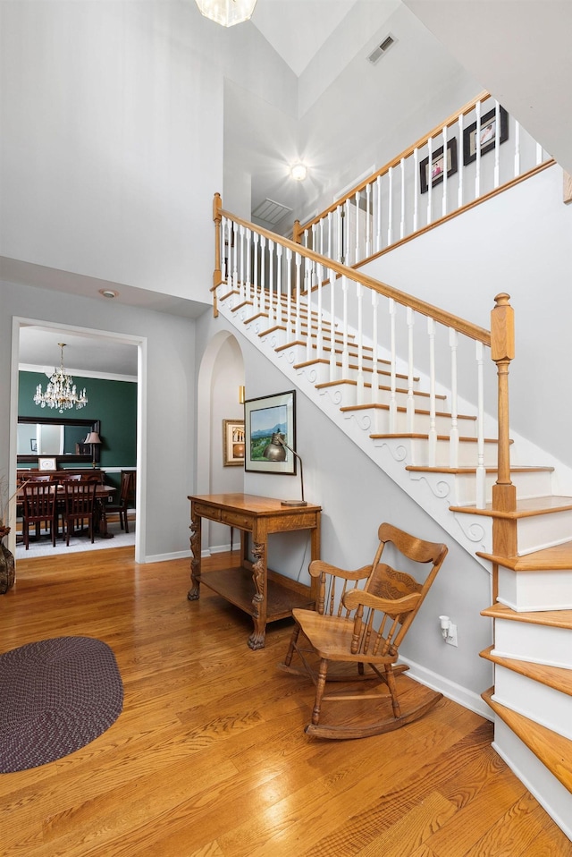 91 Twin Hills Ln, Fishersville, VA 22980 - stairs with baseboards, visible vents, a chandelier, a towering ceiling, and wood finished floors