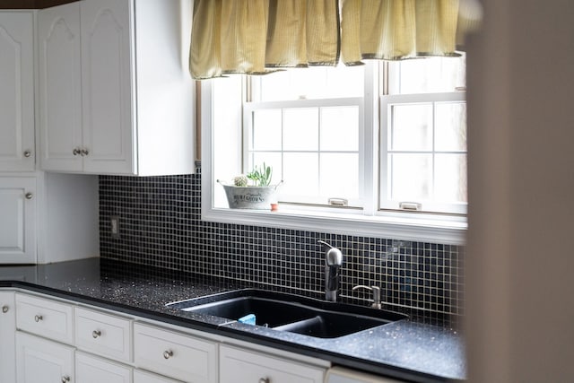 91 Twin Hills Ln, Fishersville, VA 22980 - kitchen featuring a sink, backsplash, and white cabinetry