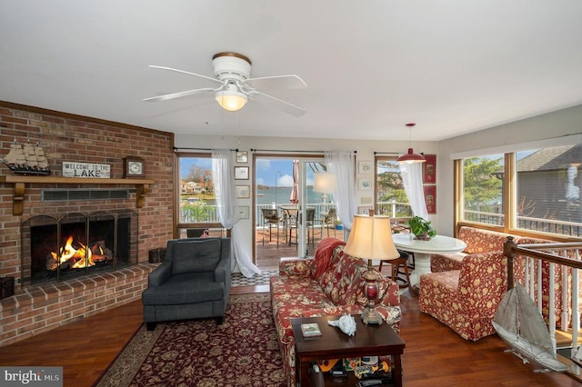 107 Ramsay Rd, Locust Grove, VA 22508 - living room with wood finished floors, healthy amount of natural light, ceiling fan, and a brick fireplace