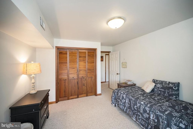 107 Ramsay Rd, Locust Grove, VA 22508 - bedroom with light colored carpet, a closet, and baseboards