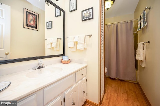 107 Ramsay Rd, Locust Grove, VA 22508 - full bath with toilet, vanity, wood finished floors, curtained shower, and baseboards