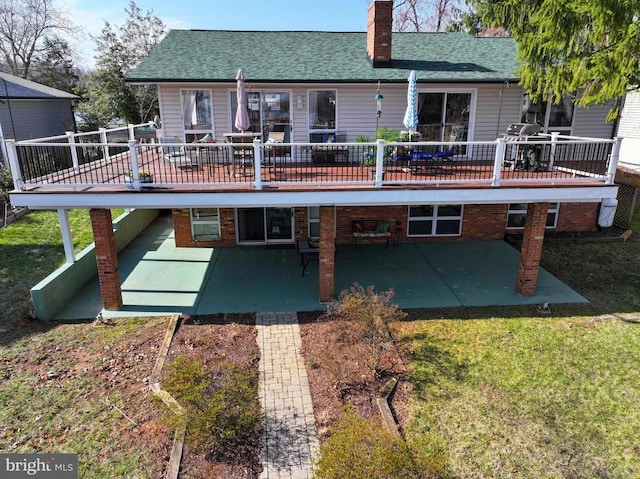 107 Ramsay Rd, Locust Grove, VA 22508 - back of property with a patio area, a wooden deck, a chimney, and a lawn