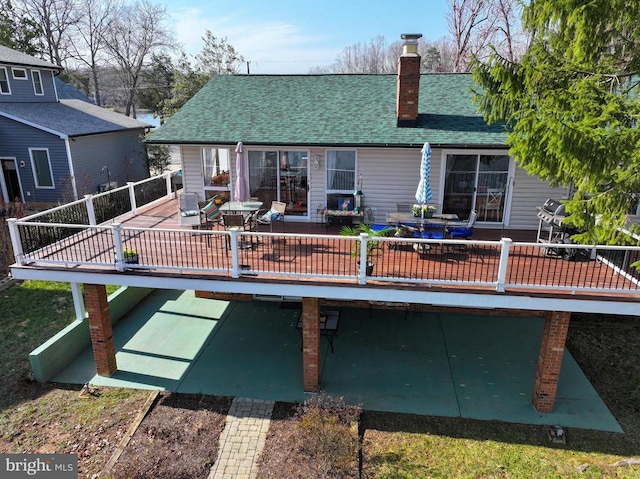 107 Ramsay Rd, Locust Grove, VA 22508 - back of property featuring a chimney, a shingled roof, a deck, and outdoor dining area