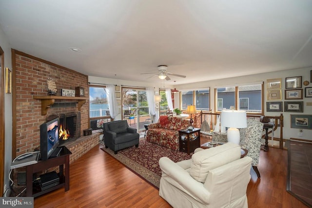 107 Ramsay Rd, Locust Grove, VA 22508 - living room with ceiling fan, a brick fireplace, wood finished floors, and baseboards