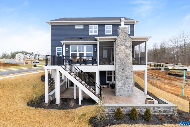 1115 Sablewood Dr, Charlottesville, VA 22911 - back of property featuring stairway, a patio area, and a sunroom