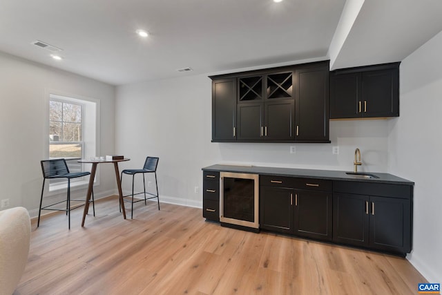 1115 Sablewood Dr, Charlottesville, VA 22911 - bar with a sink, light wood-style flooring, baseboards, and beverage cooler