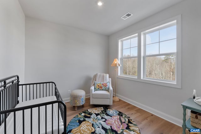 1115 Sablewood Dr, Charlottesville, VA 22911 - bedroom with a crib, baseboards, visible vents, and wood finished floors