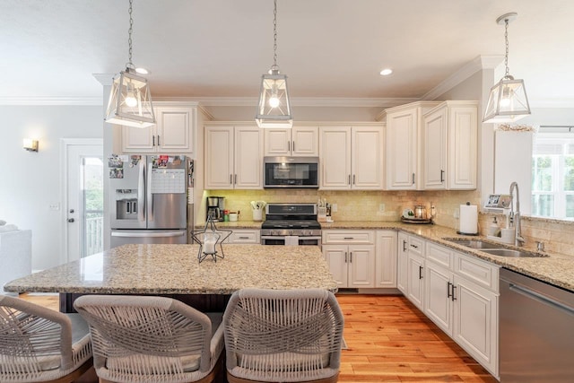 731 Hidden Brook Rd, Mcgaheysville, VA 22840 - kitchen featuring appliances with stainless steel finishes, ornamental molding, tasteful backsplash, light wood finished floors, and hanging light fixtures