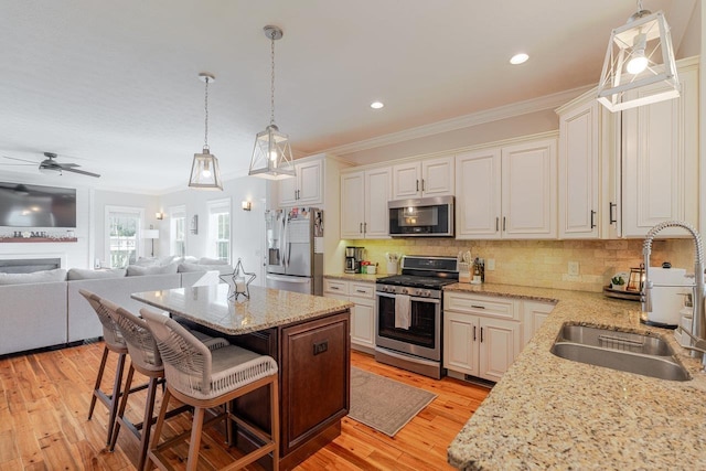 731 Hidden Brook Rd, Mcgaheysville, VA 22840 - kitchen with stainless steel appliances, ornamental molding, open floor plan, a kitchen island, and tasteful backsplash