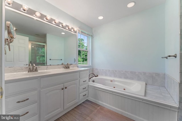  - full bath with a stall shower, double vanity, a whirlpool tub, and wood finished floors