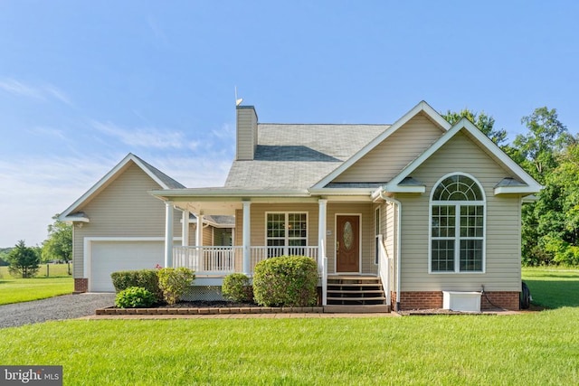  - view of front of home with covered porch, a front yard, a chimney, driveway, and an attached garage